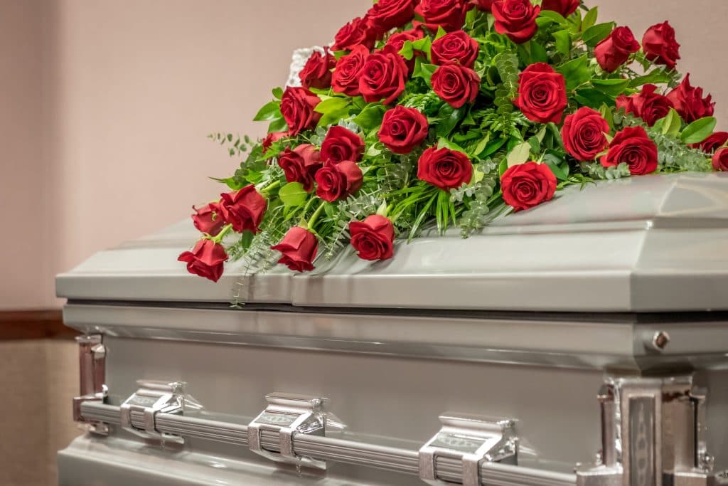 Roses on top of a funeral casket