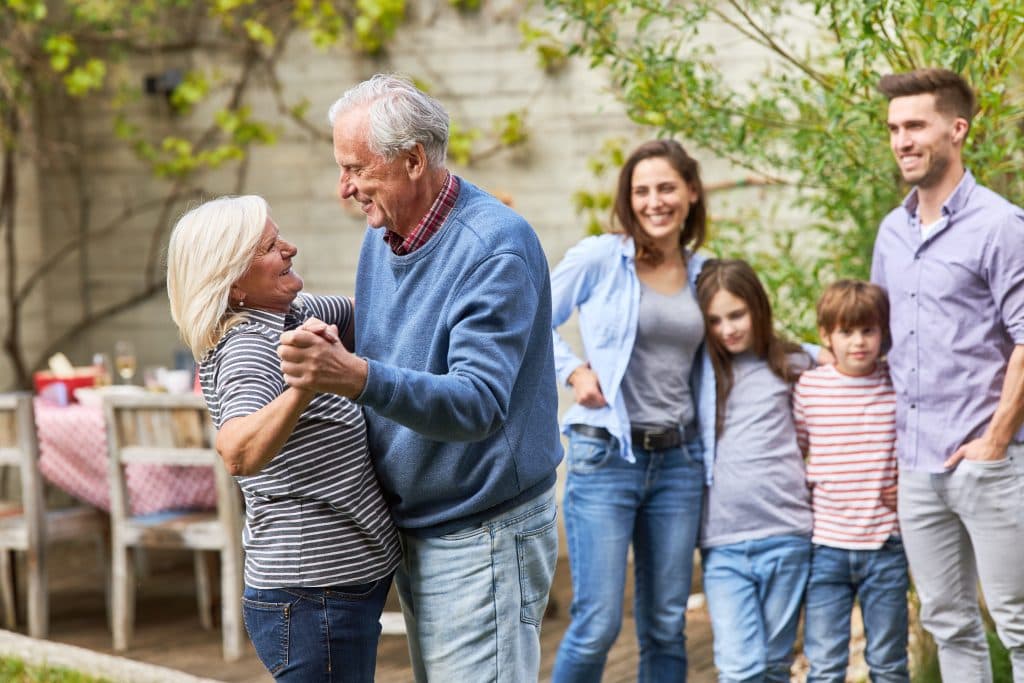 Family gathered around grandparents dancing